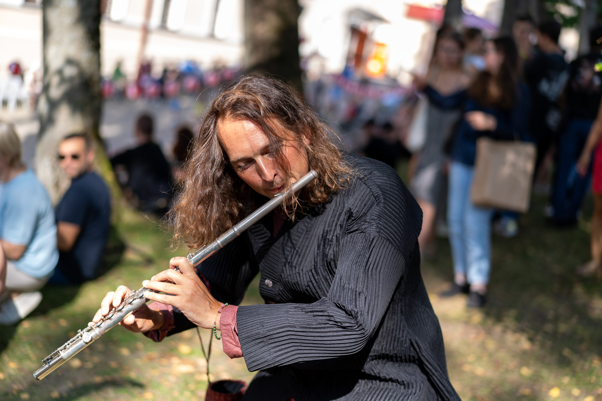 Mikey plays his flute in the crowd