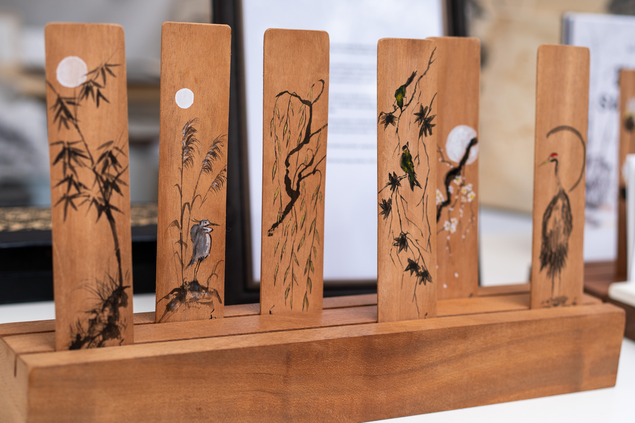 Wooden bookmarks are painted with images of nature, made by the artist Indré Beinarte